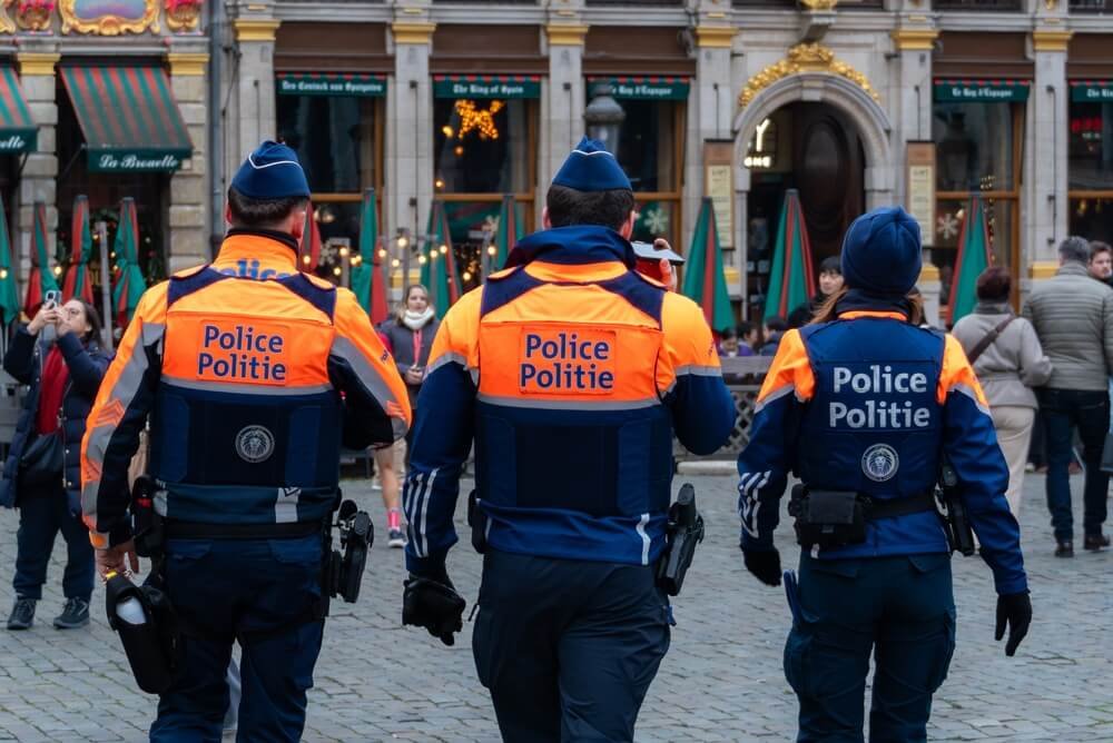 Drie toekomstige politie-inspecteurs in uniform tijdens een praktische simulatieoefening in stedelijk gebied.